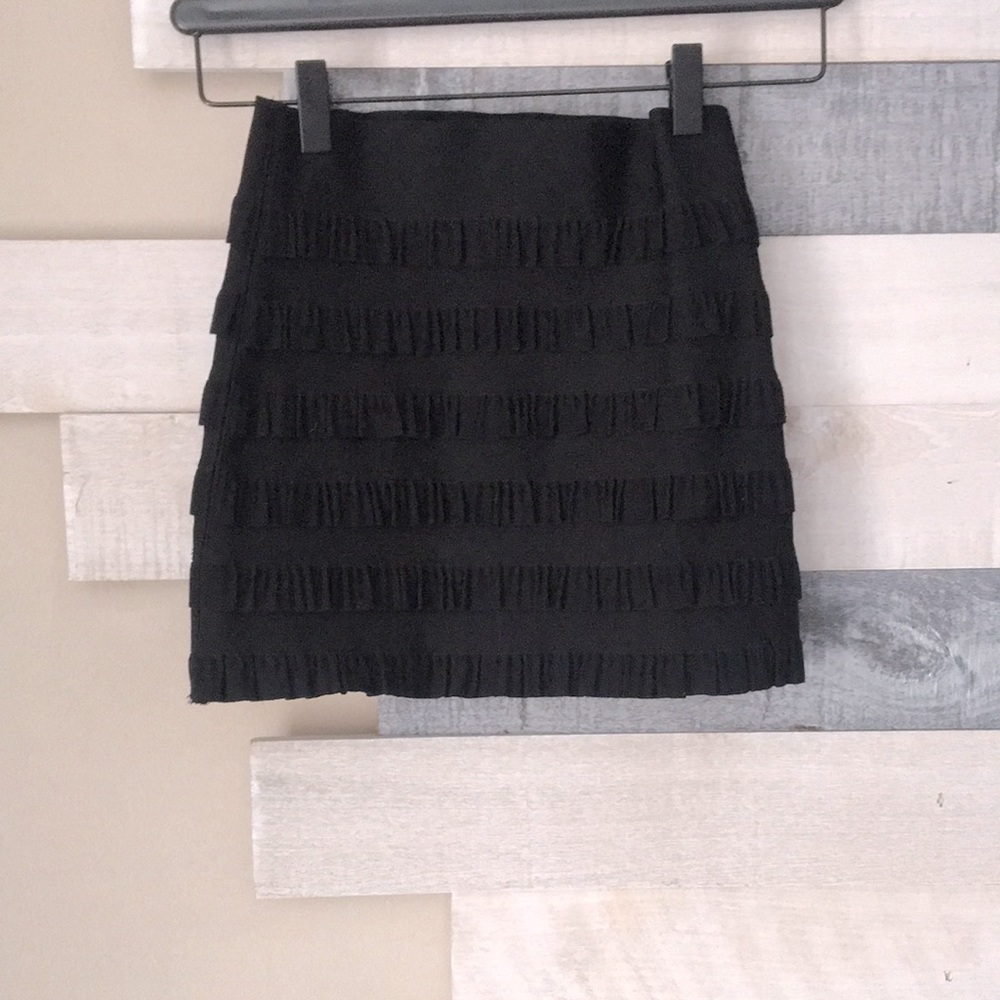 Tight black skirt with ruffle details